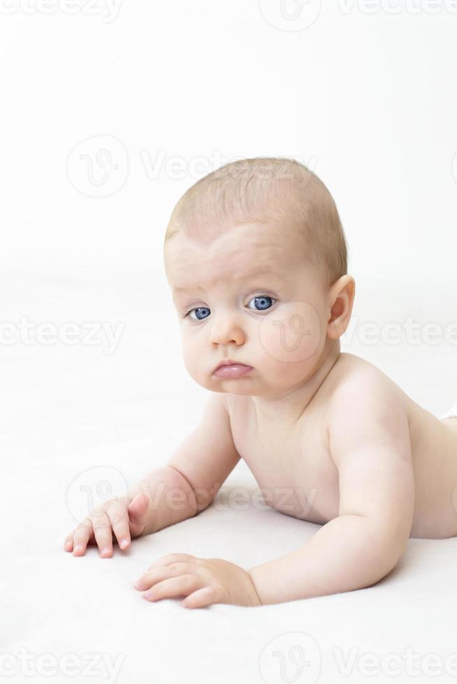 Cute baby girl lying on bed photo