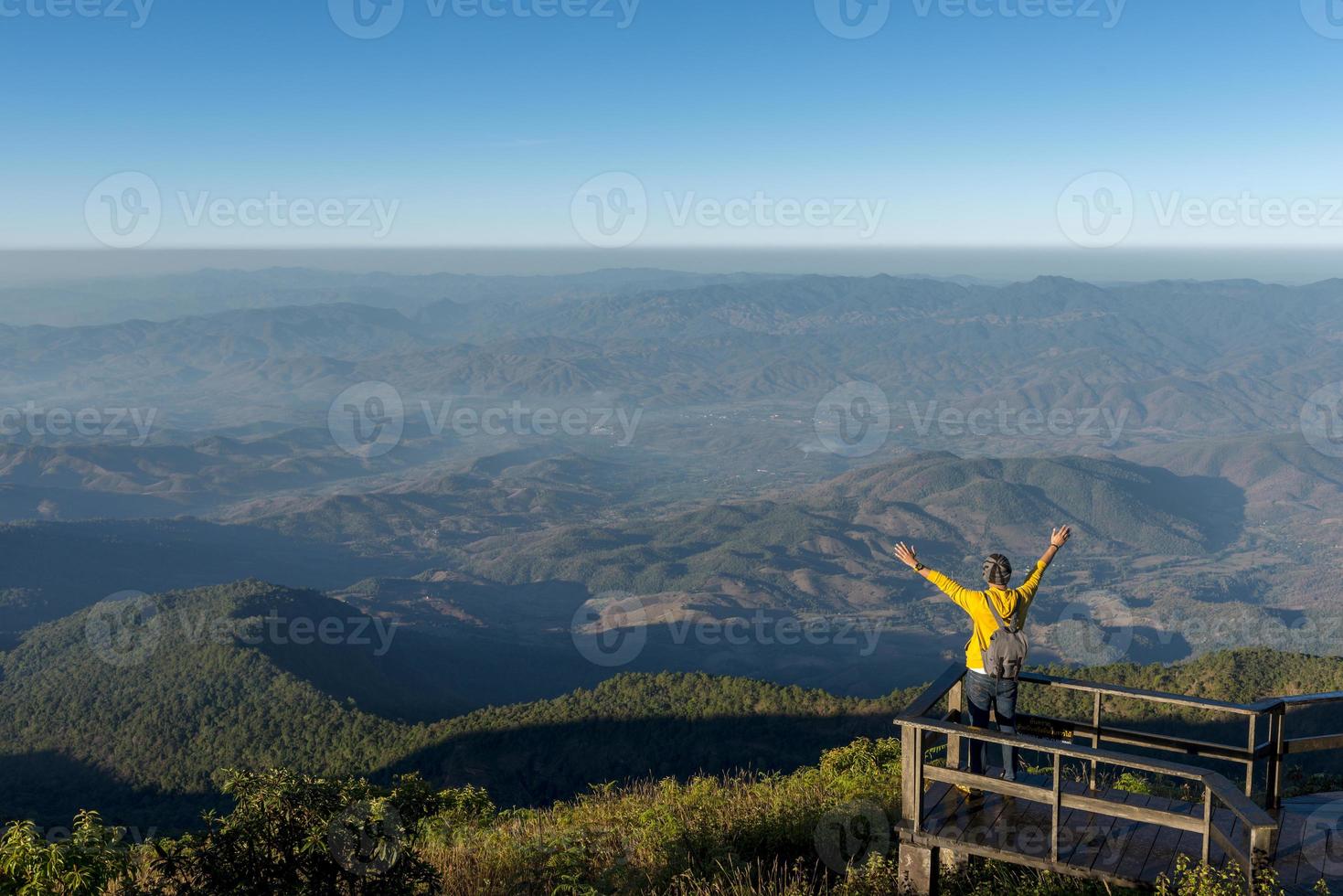 Tourist man is standing at viewpoint photo