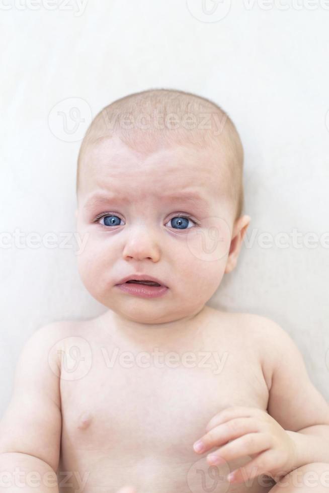 Cute baby girl lying on bed photo