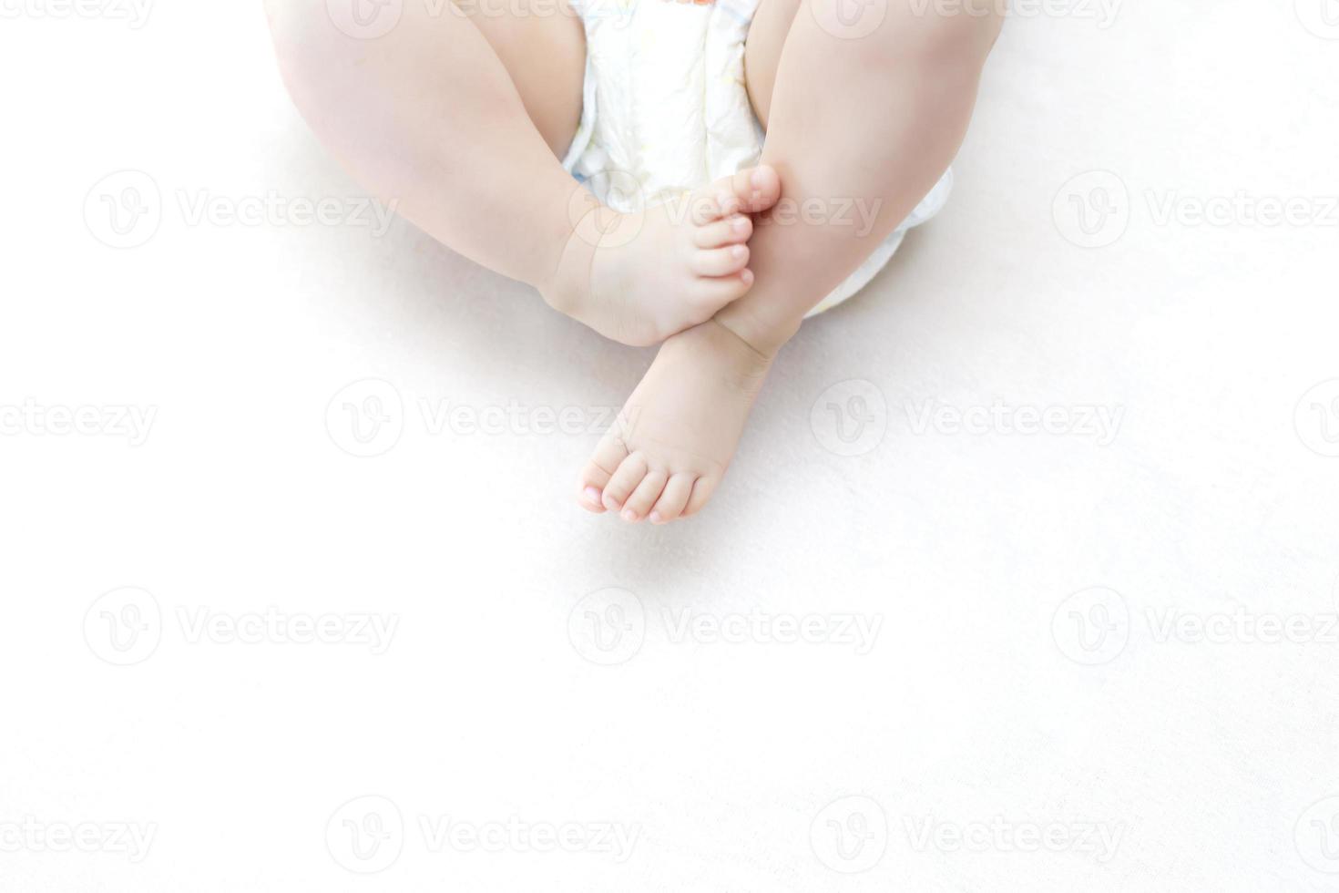 Cute baby girl lying on bed photo