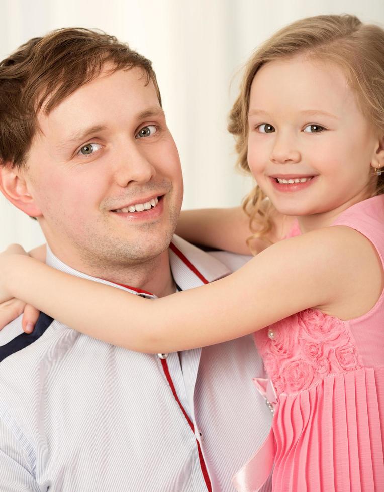 Father holding daughter photo