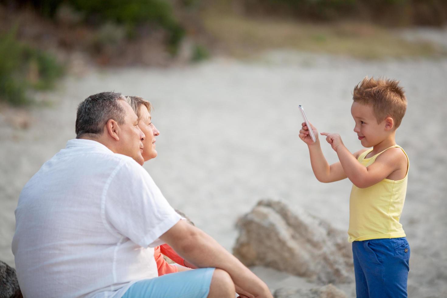 Boy taking a photo of his grandparents