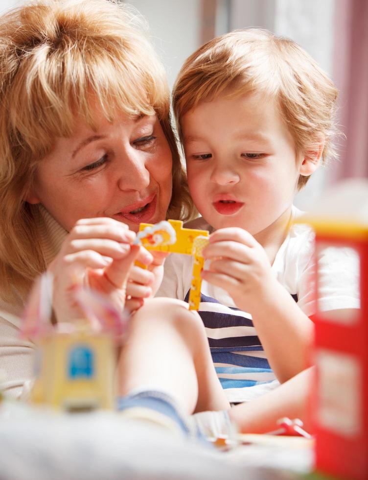 Grandmother playing with her grandson photo