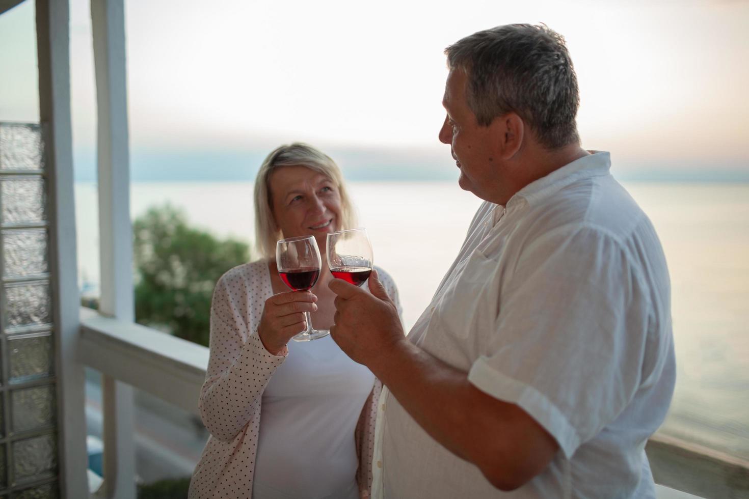 Mature couple enjoying wine photo