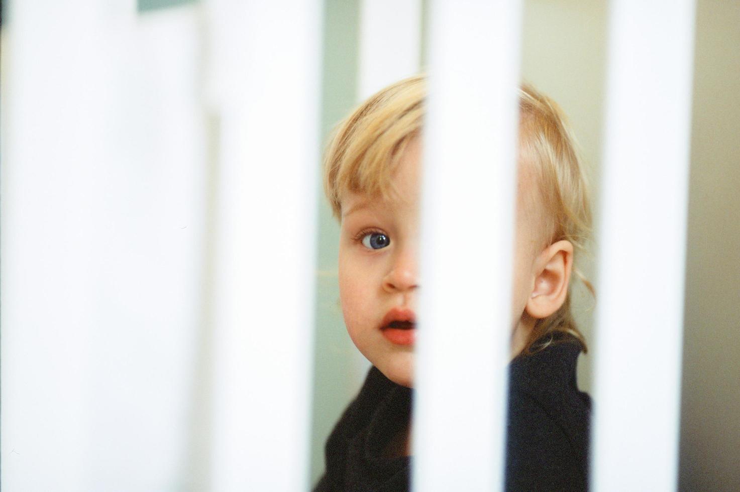 Child in a white crib photo