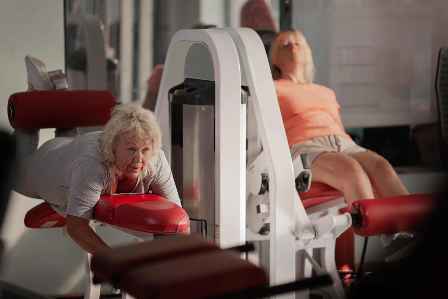 Two women exercising in a gym photo