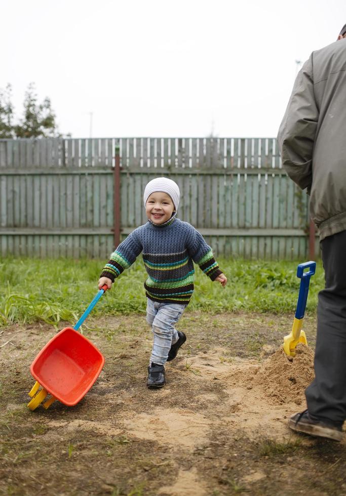 Happy grandson runs with grandfather photo