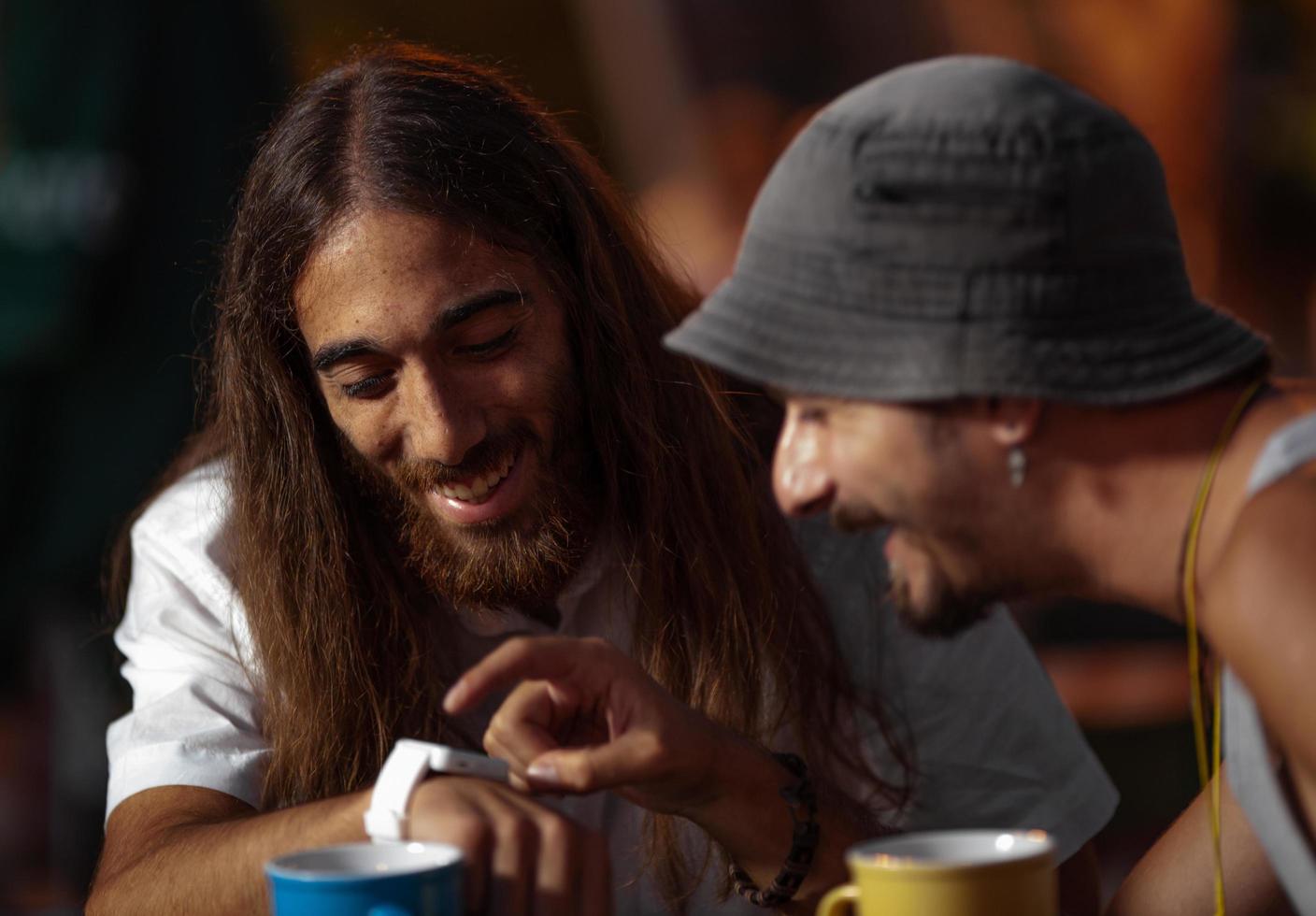 Two men looking at a watch photo