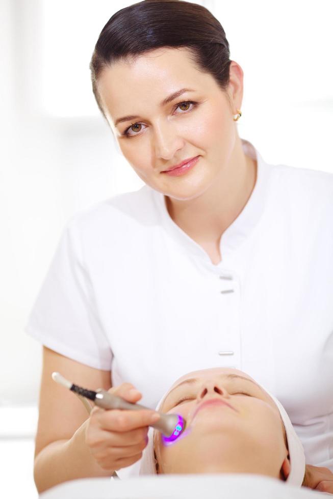 Cosmetician giving a lifting procedure photo