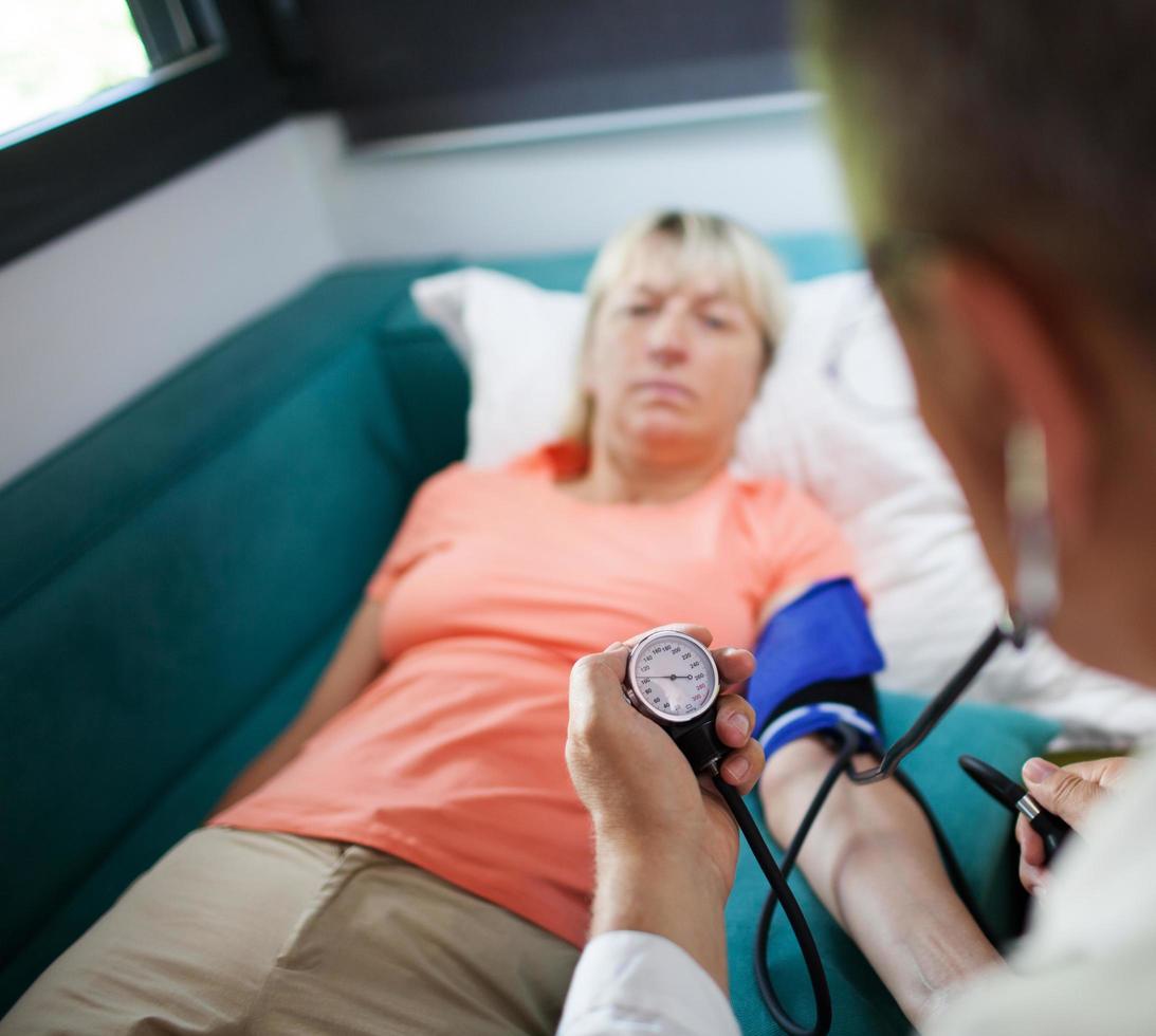 Woman getting her blood pressure checked photo