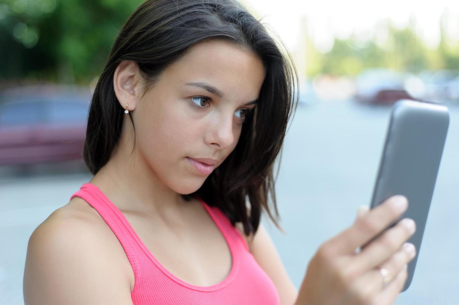 Girl using a tablet outside photo