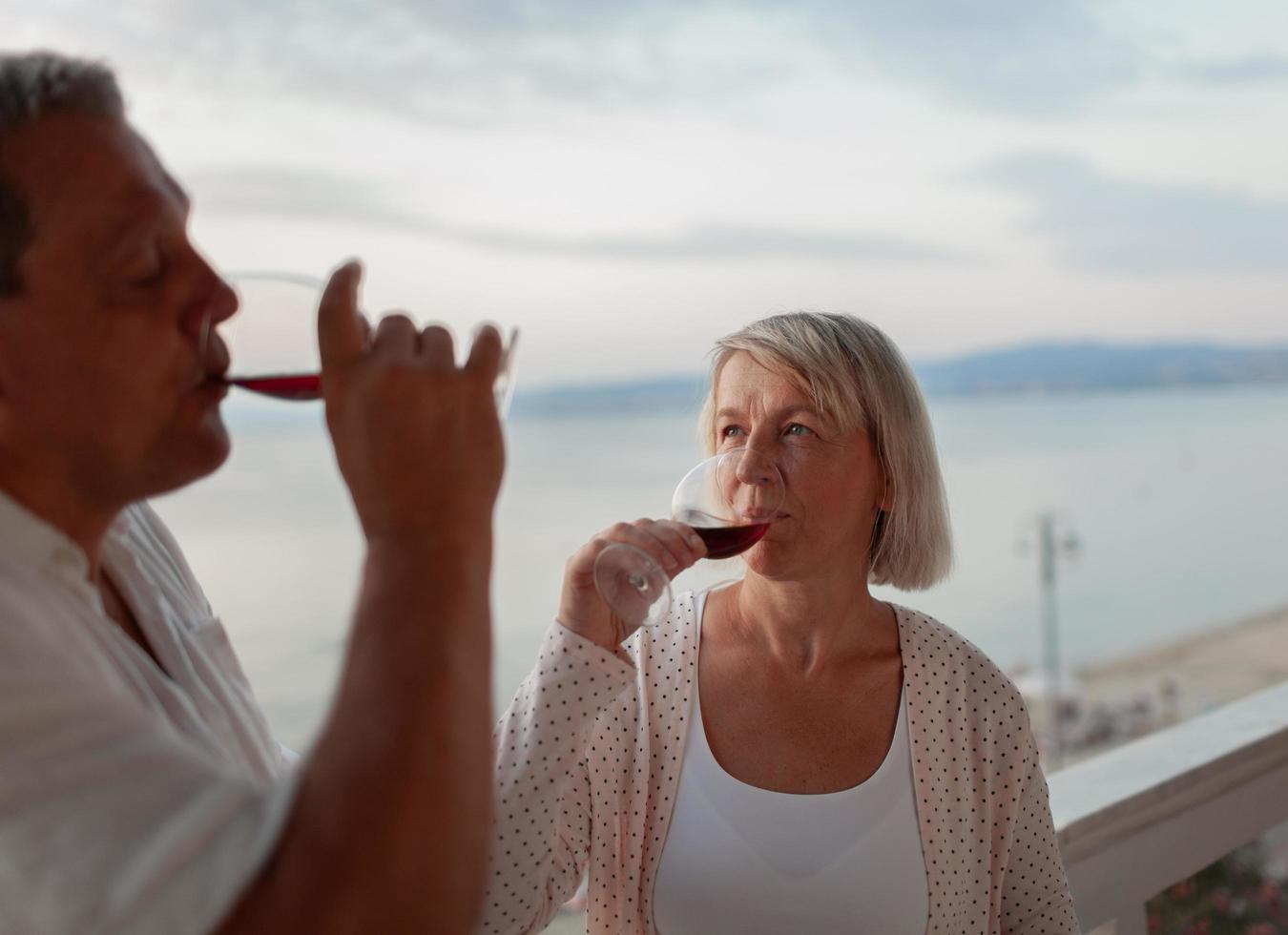 Mature couple sipping wine photo