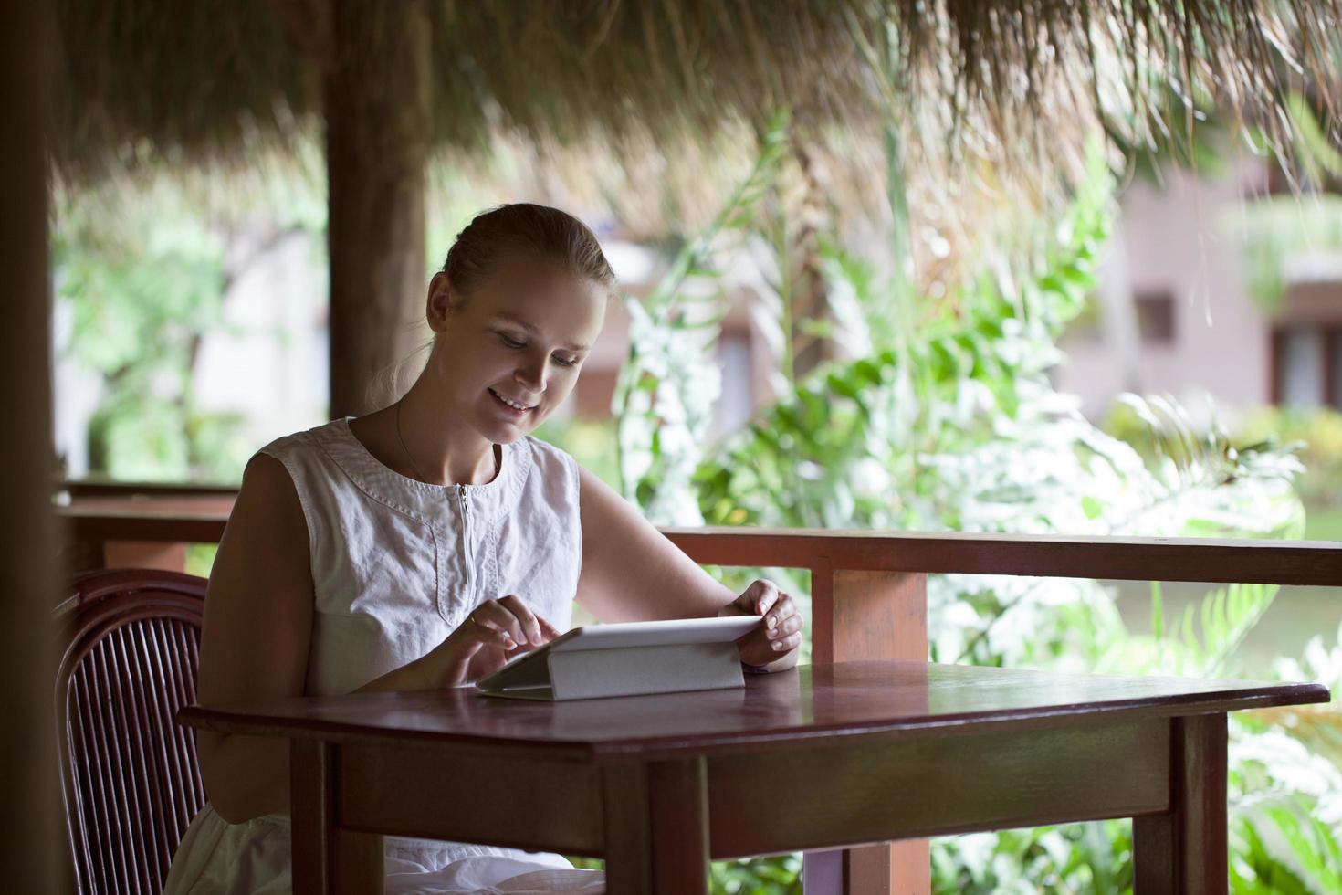 Woman using tablet in an outdoor cafe photo