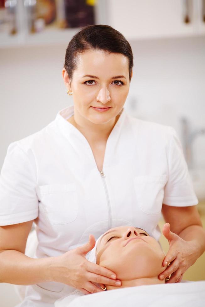 Facial treatment with massage therapist photo