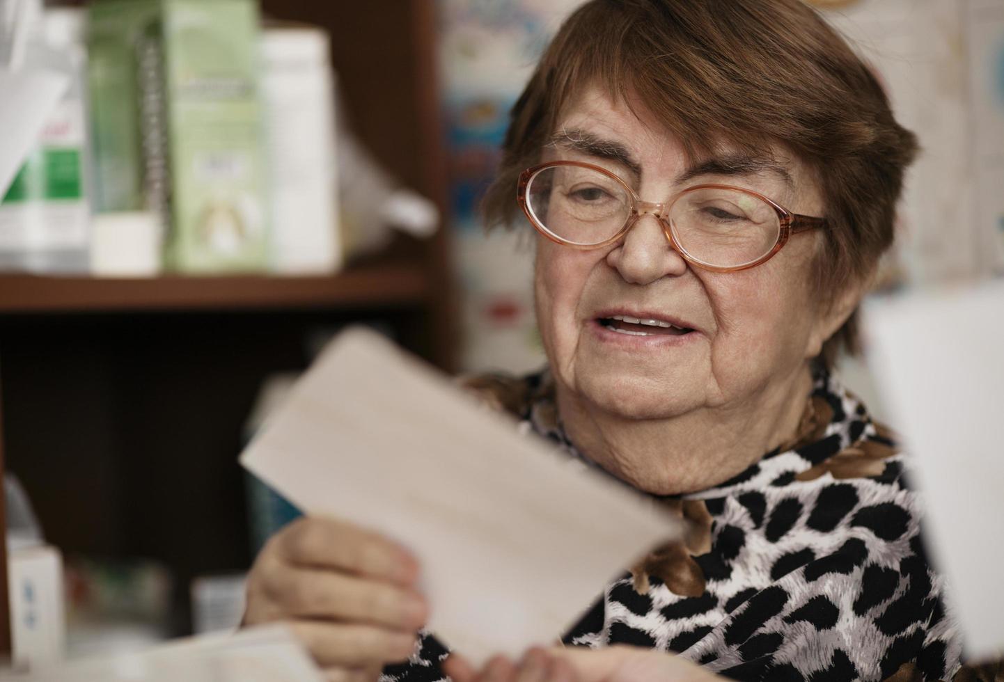 Elderly woman reading a letter photo