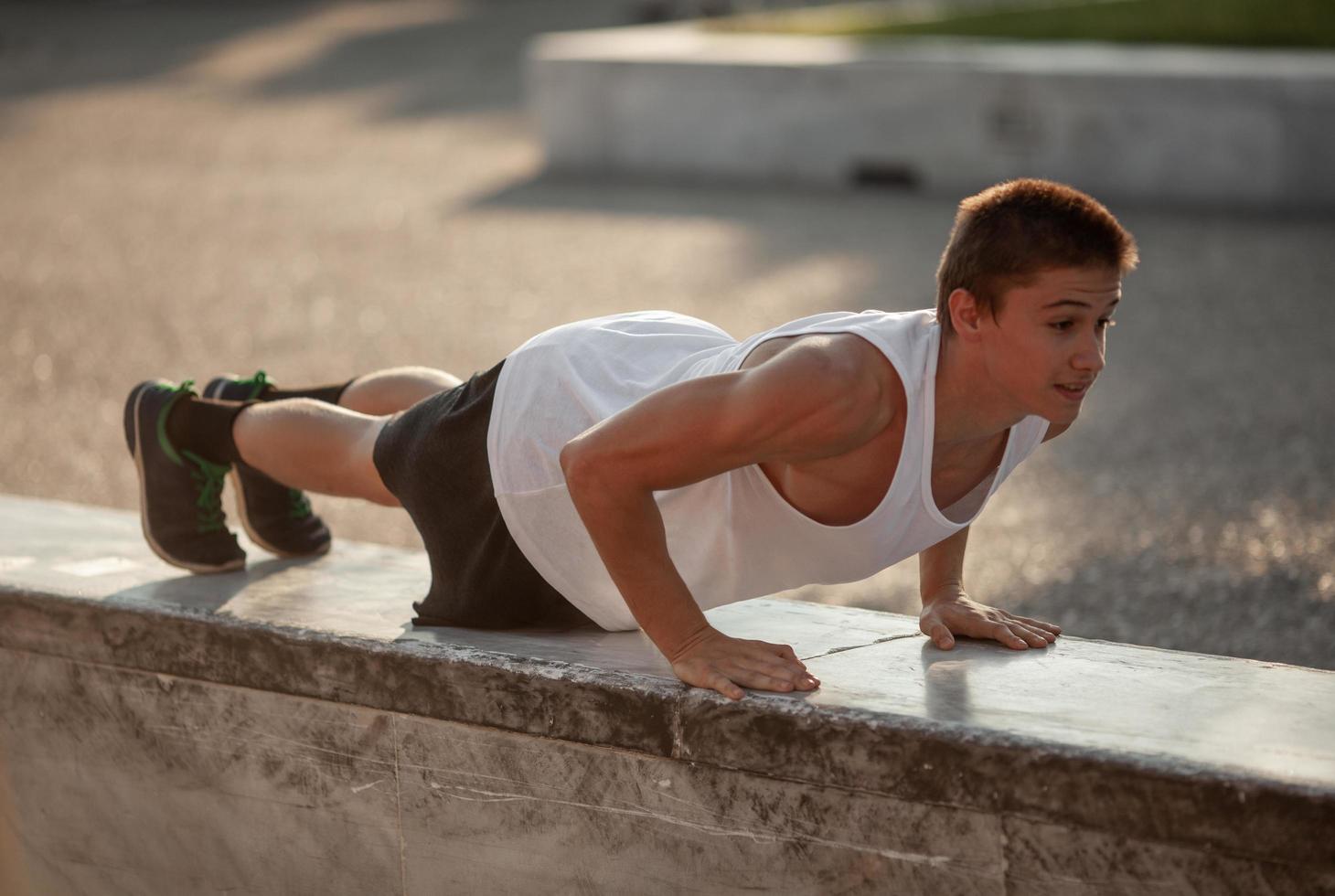 Young man doing push-ups photo