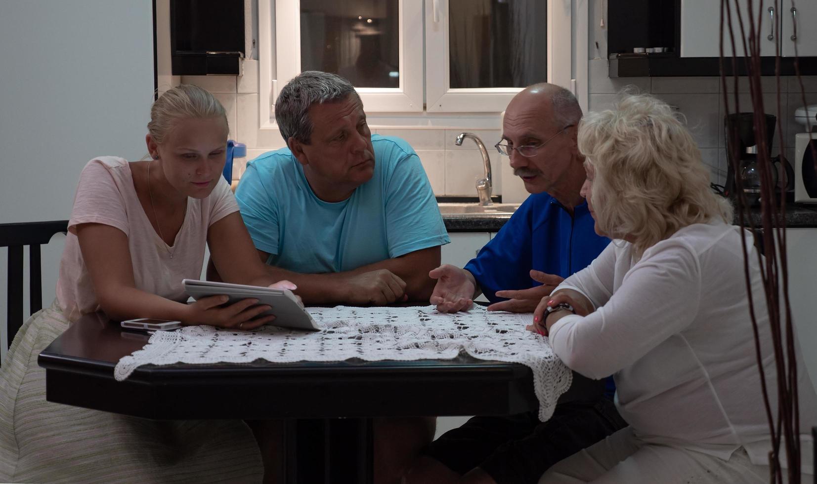 Family enjoying time together at a kitchen table photo