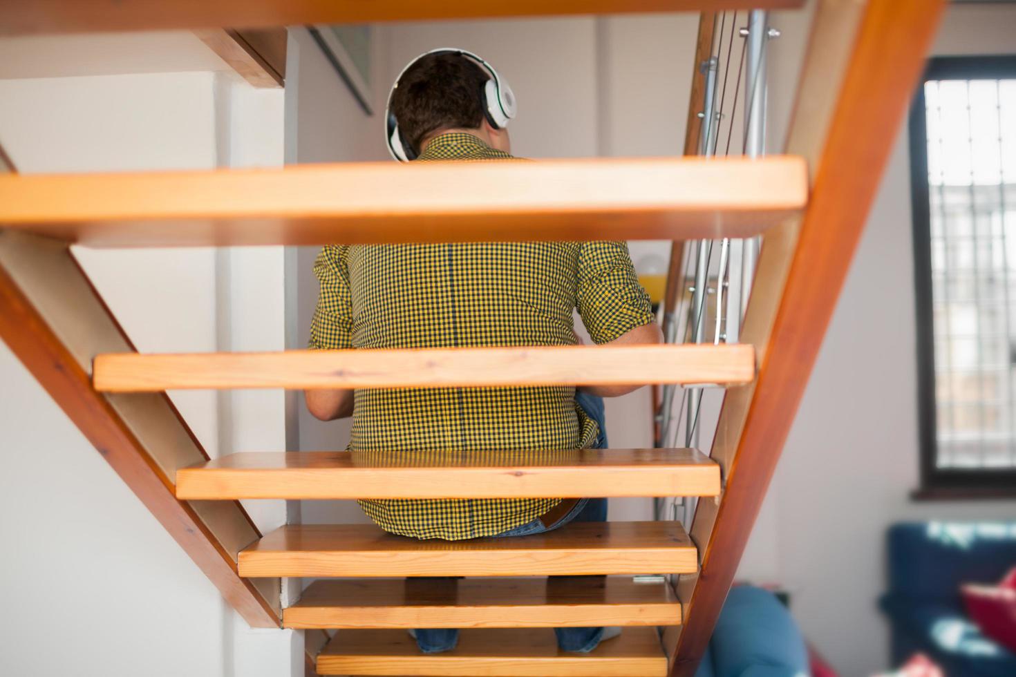 hombre escuchando musica en las escaleras foto