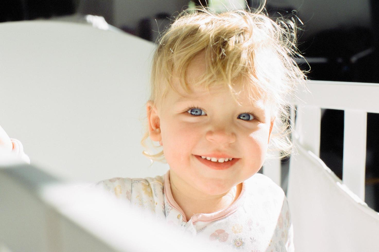 Smiling child in a crib photo