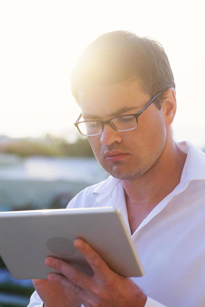 Man using a tablet outside photo