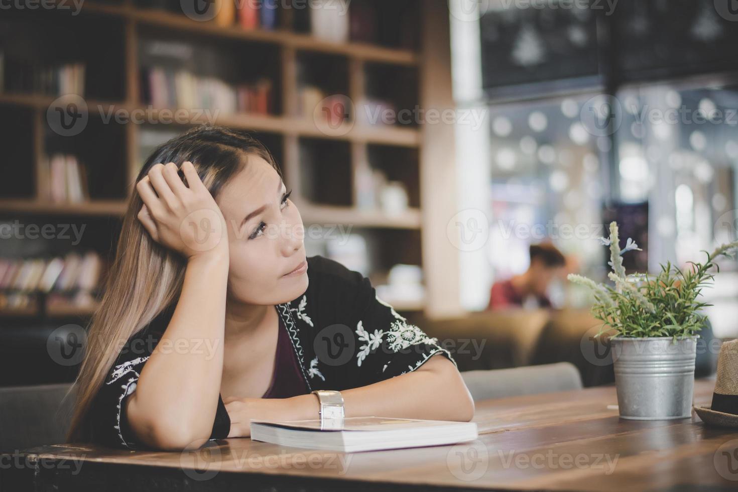 Business woman feeling stressed while sitting at cafe photo