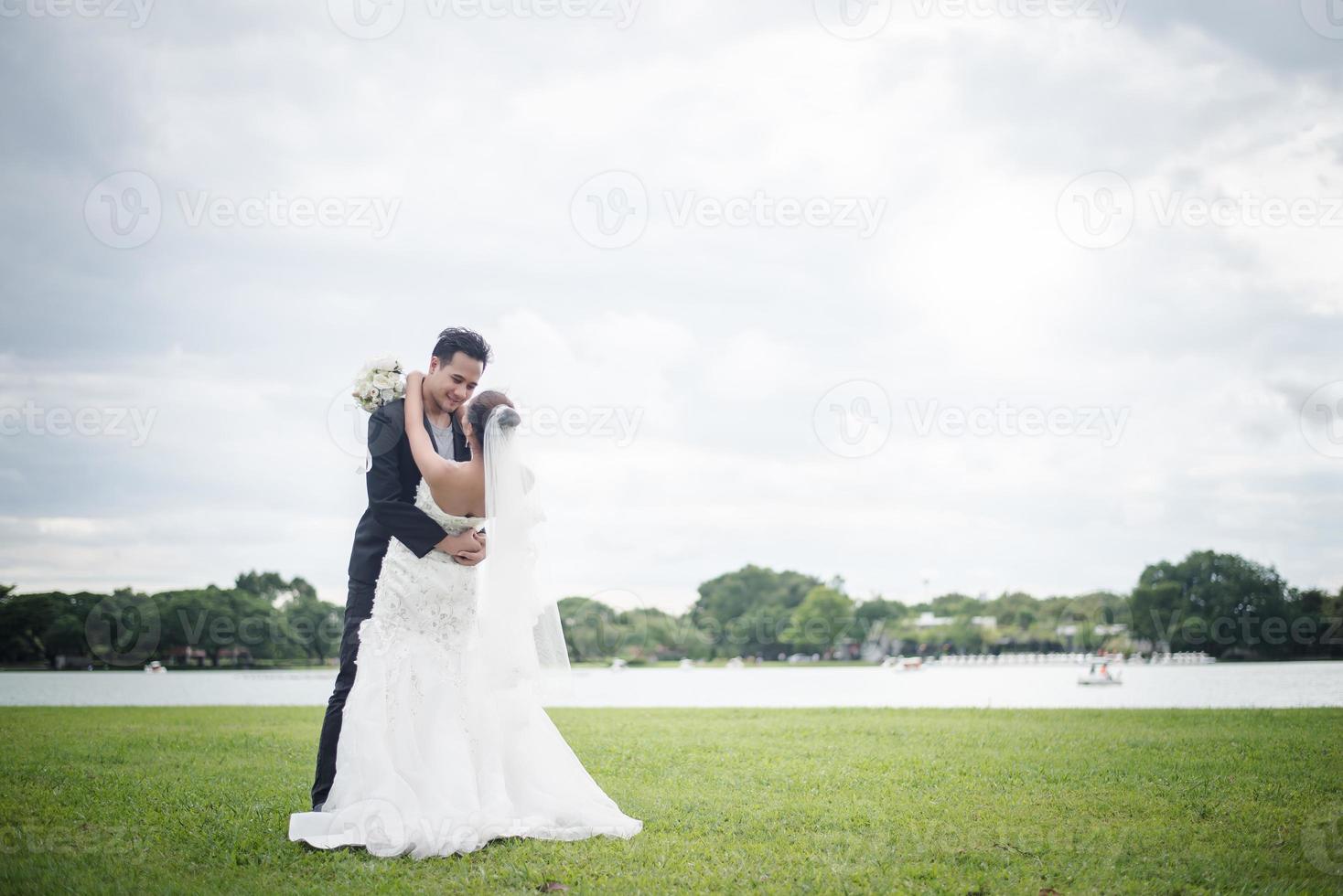 Pretty bride and handsome groom gorgeous posting in the nature photo