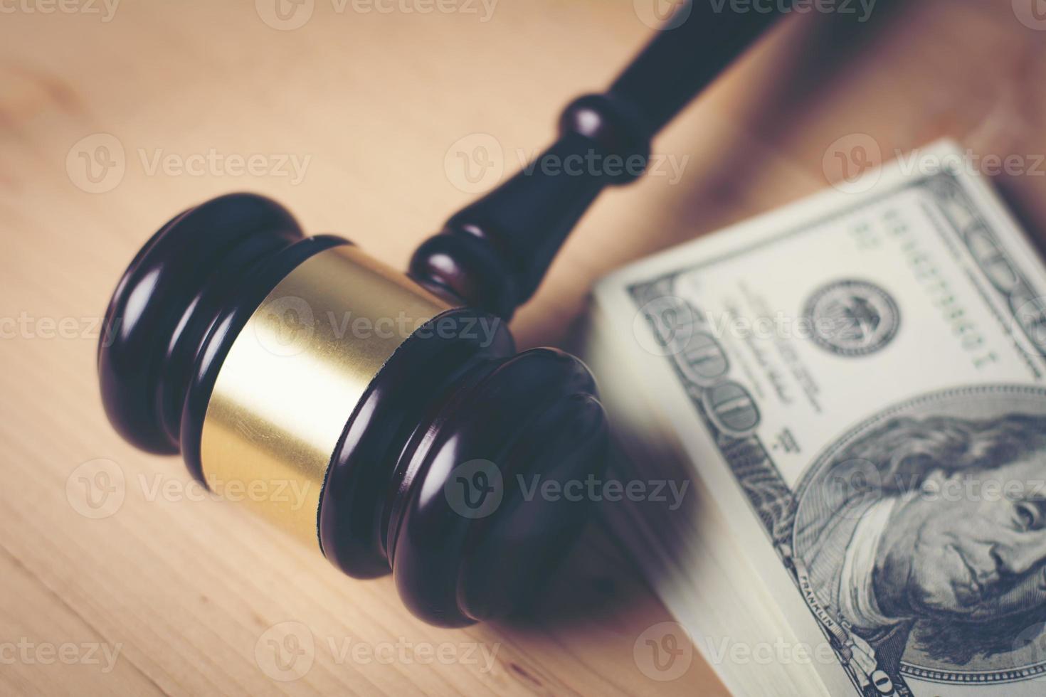 Concept of legal court gavel on assorted cash, close-up photo