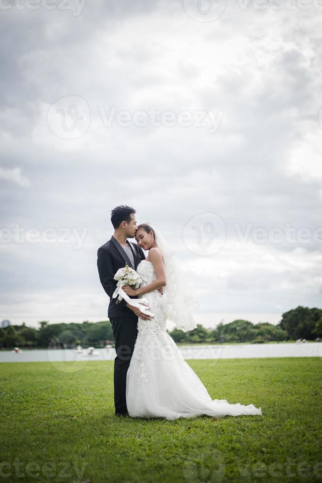 Pretty bride and handsome groom gorgeous posting in the nature photo