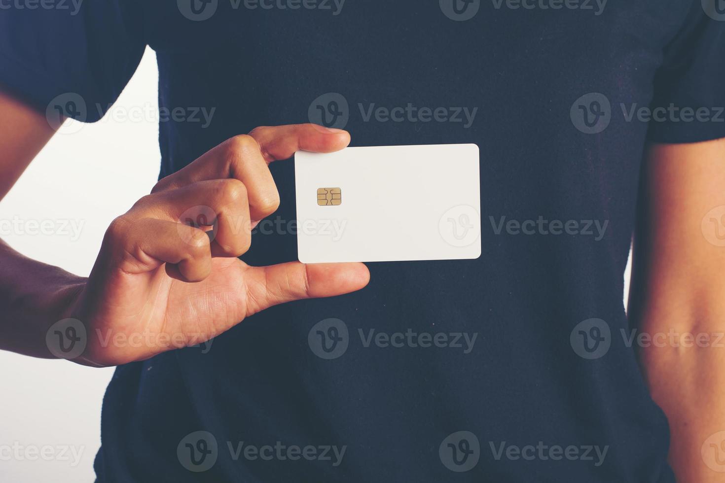 Close-up of a woman's hand holding a blank card isolated on white background photo