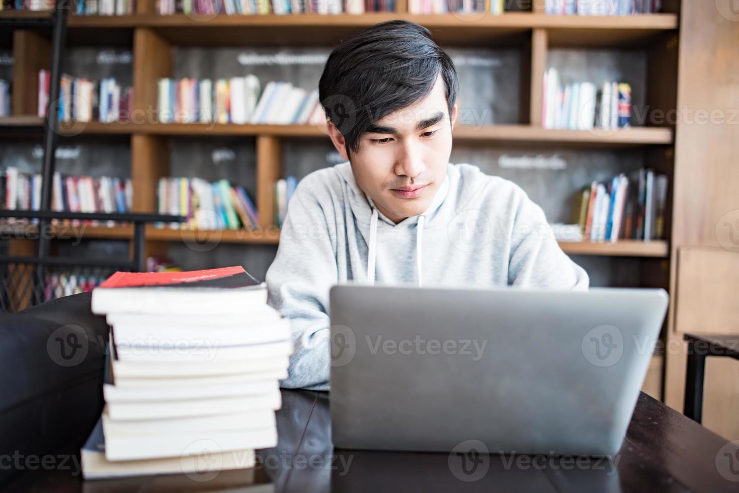 Young student man tired of computer at cafe photo