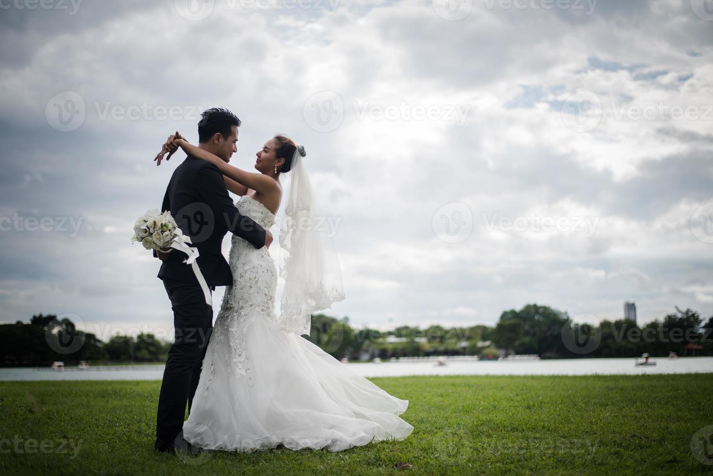 Pretty bride and handsome groom gorgeous posting in the nature photo