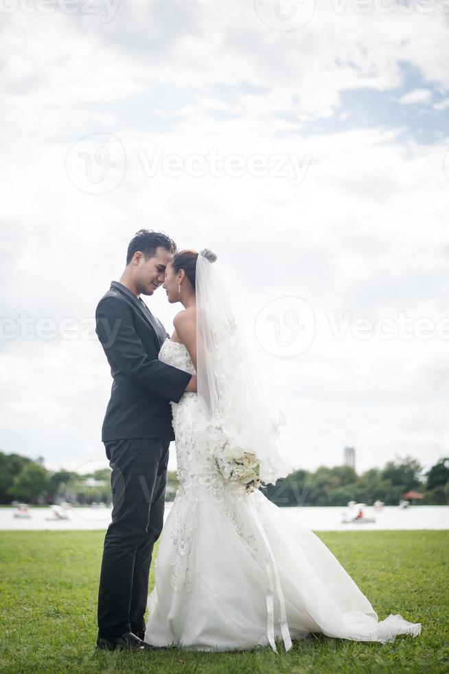 Pretty bride and handsome groom gorgeous posting in the nature photo