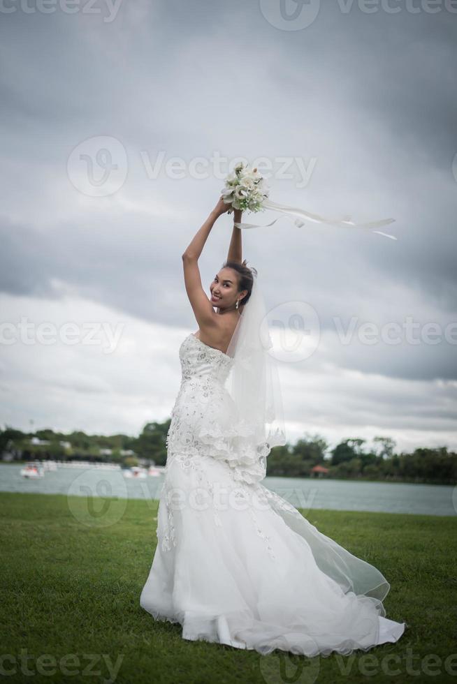 Beautiful bride with flowers, wedding makeup and hairstyle photo