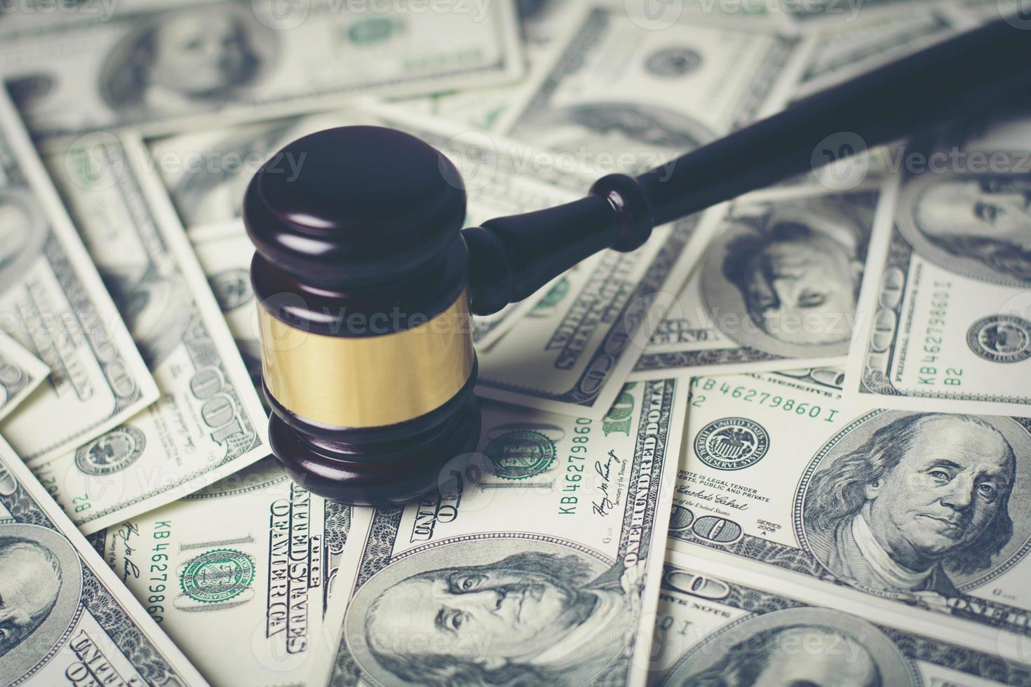 Concept of legal court gavel on assorted cash, close-up photo