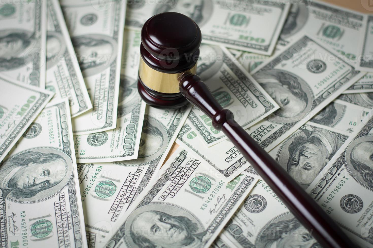 Concept of legal court gavel on assorted cash, close-up photo