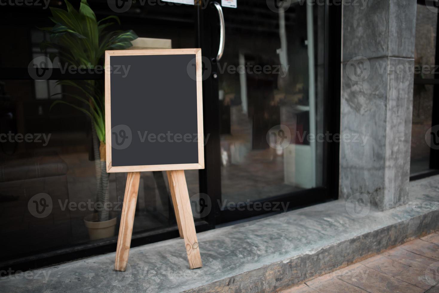 Blank black chalkboard in front of cafe photo