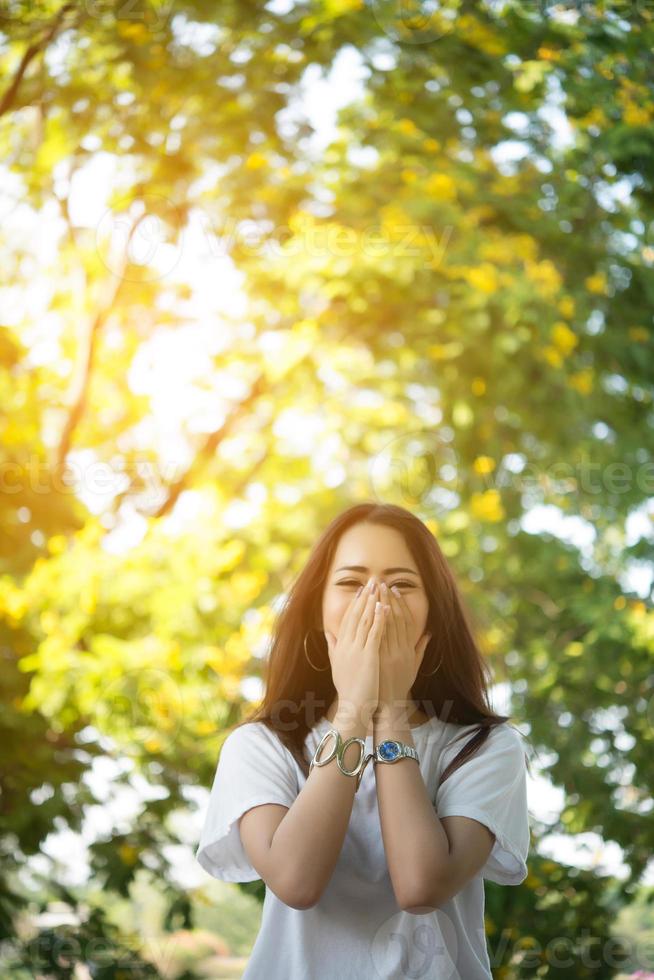 Portrait of a smiling girl relaxing in a nature park outdoors photo