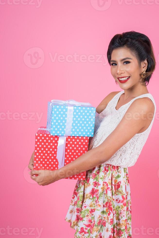 Beautiful happy woman with surprise gift boxes photo