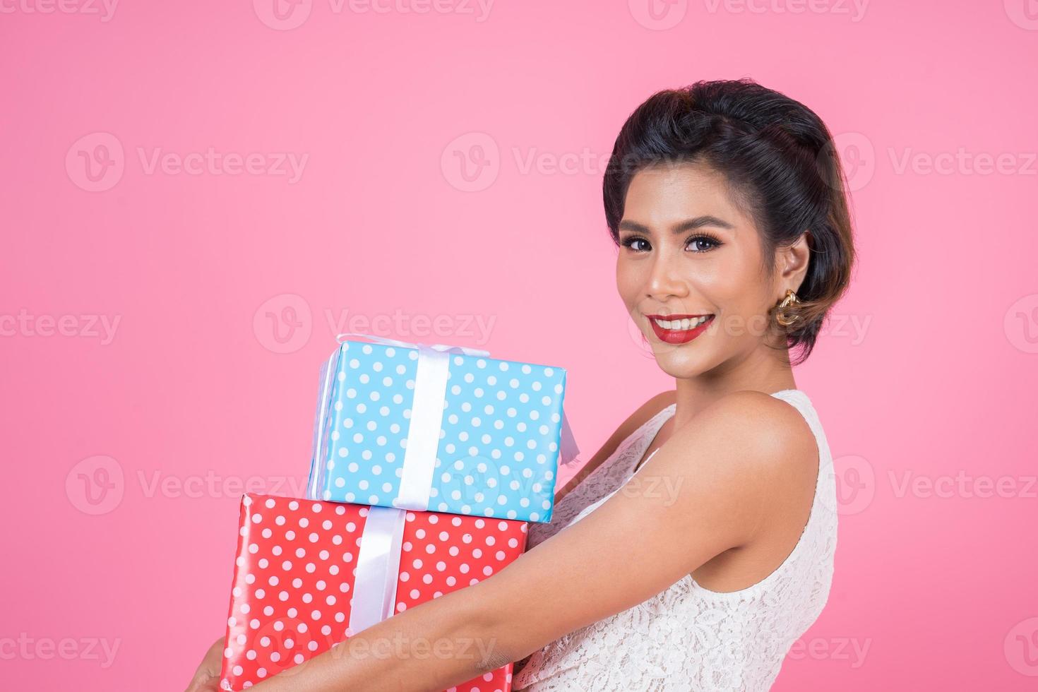 Beautiful happy woman with surprise gift boxes photo