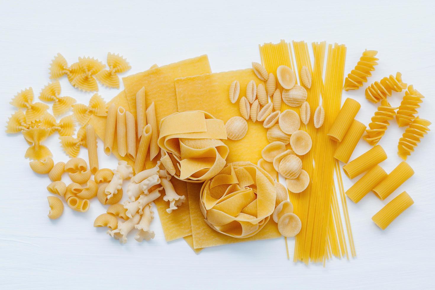 Assorted pasta on white photo