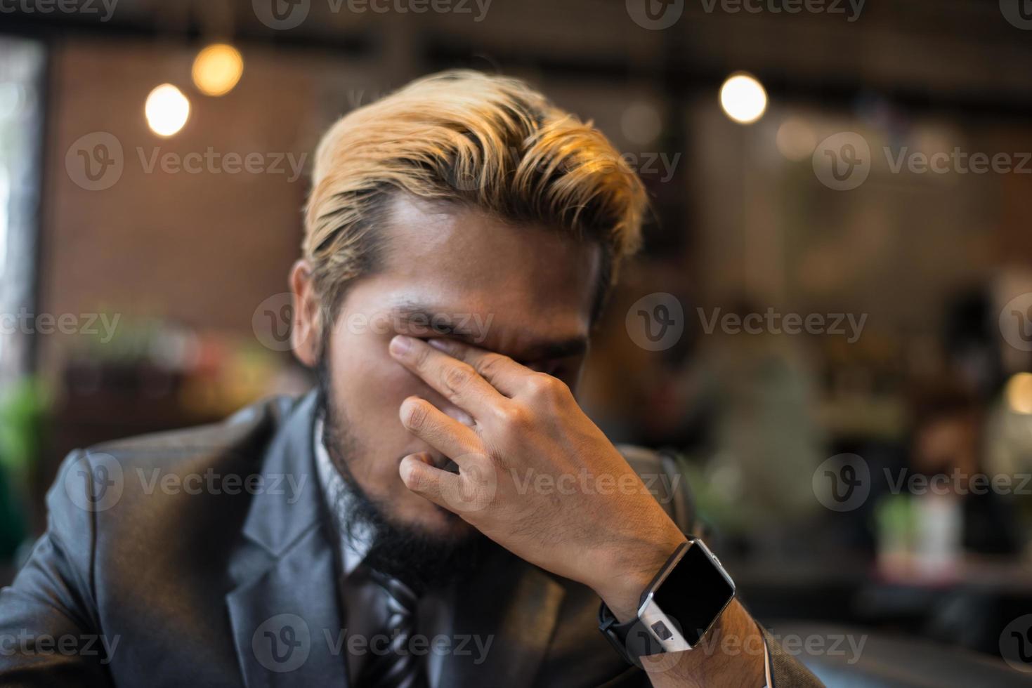 Businessman thinking about a problem at cafe photo