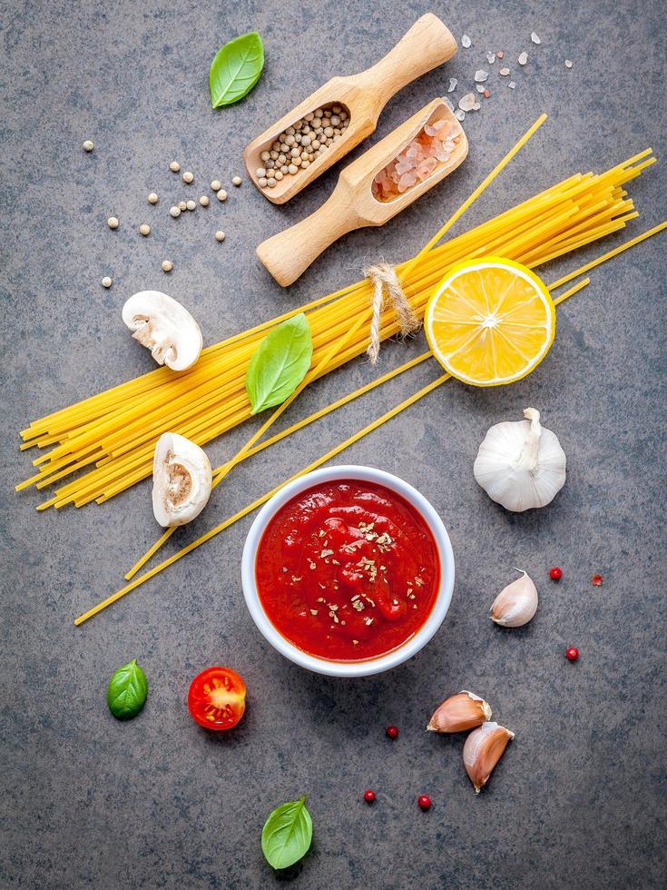 Spaghetti ingredients on a dark background photo