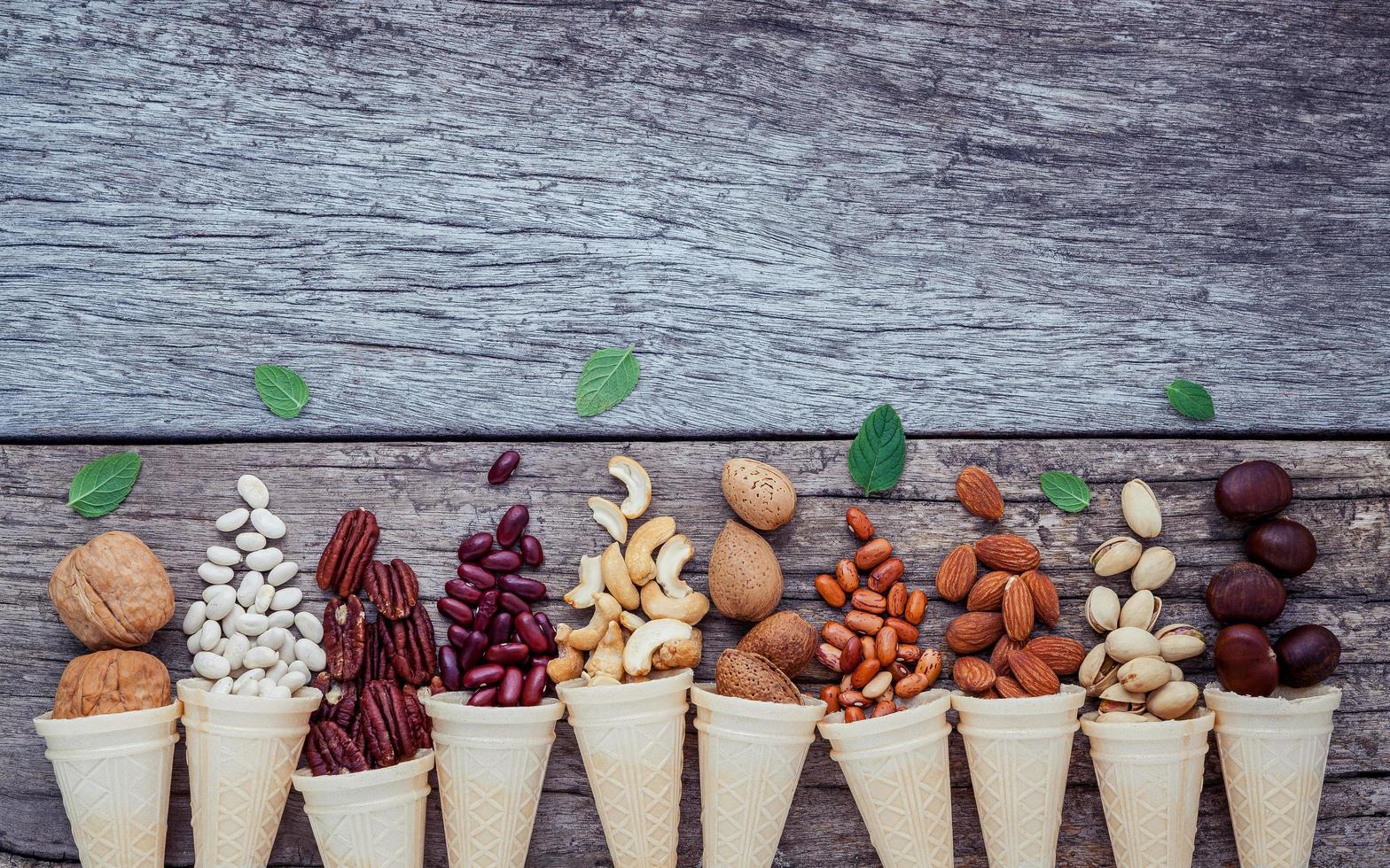 Nuts and ice cream cones on a wooden background photo