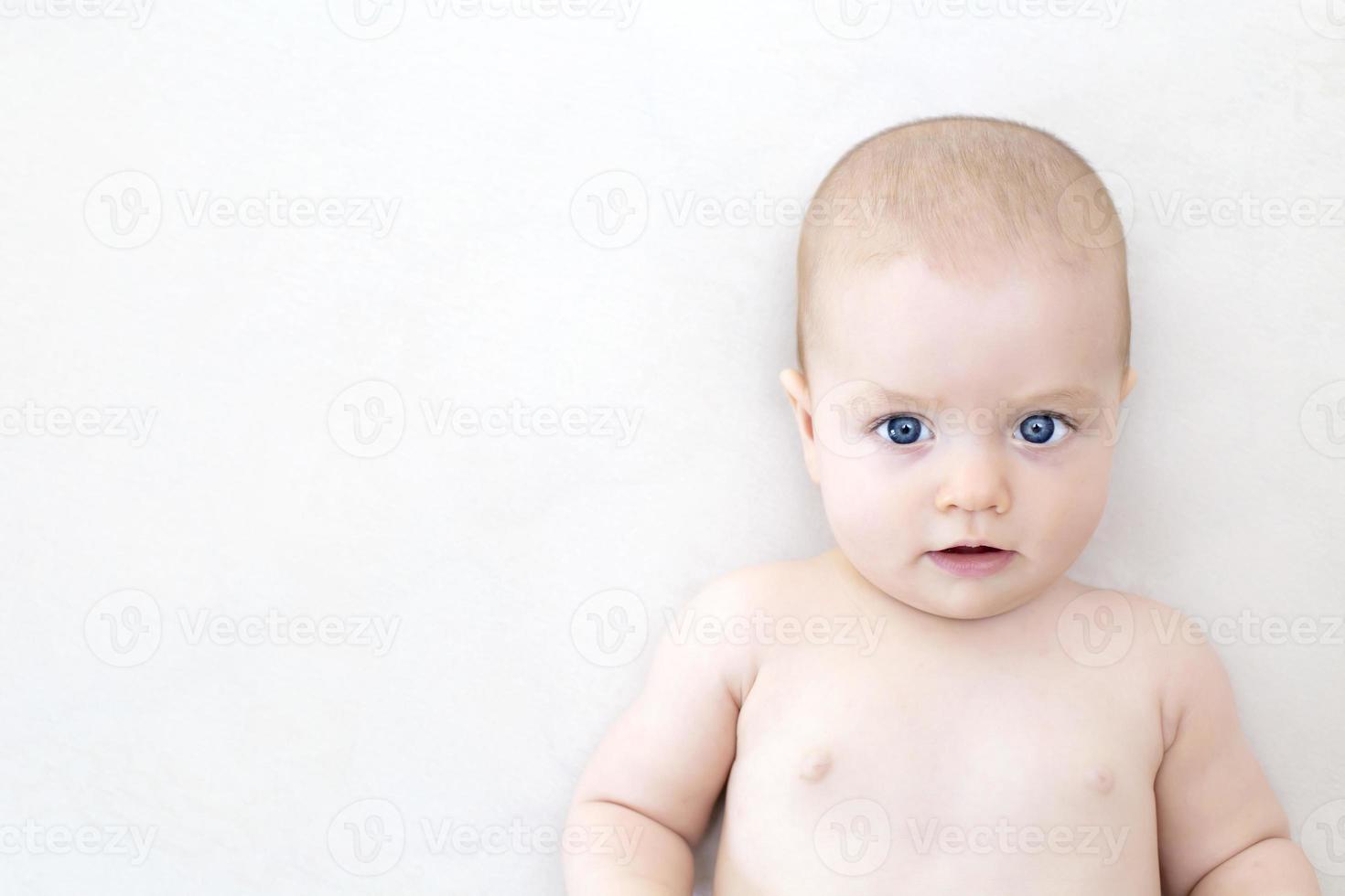 Cute baby girl lying on bed photo