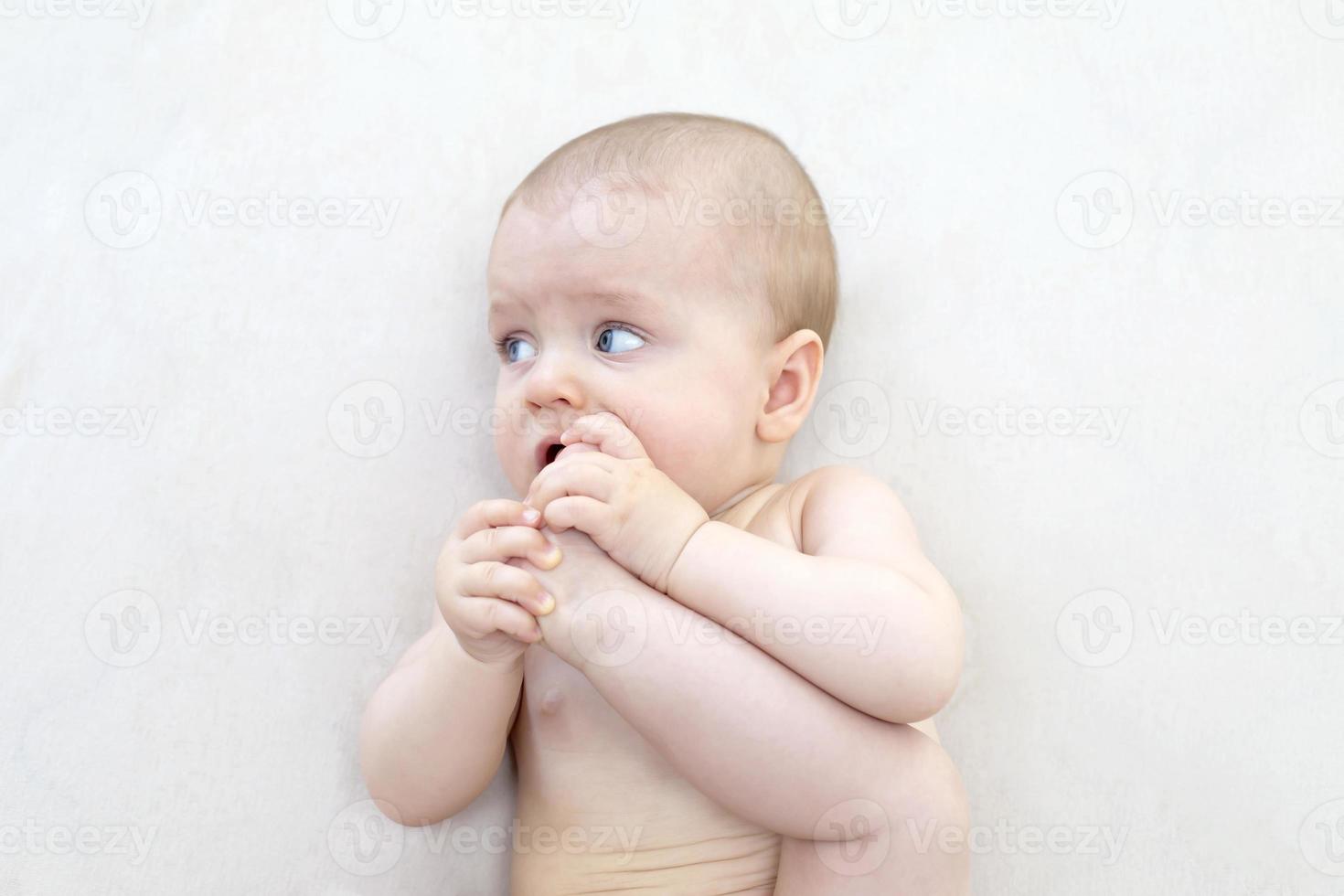 Cute baby girl lying on bed photo