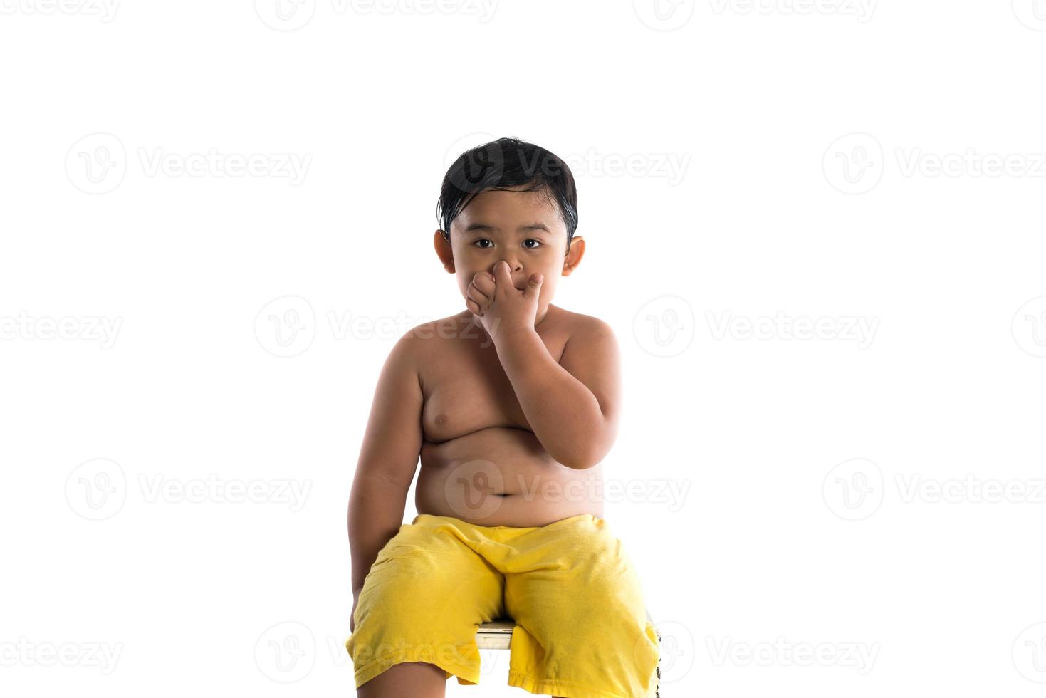 Portrait of a little boy sitting isolated on white background photo