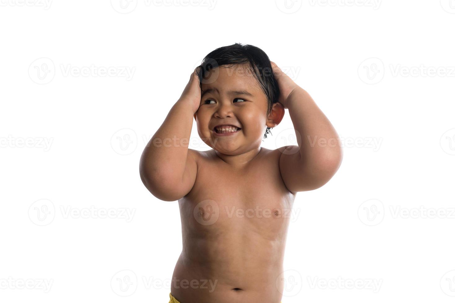 Happy little cute Asian boy cute smiling to camera isolated on white background photo