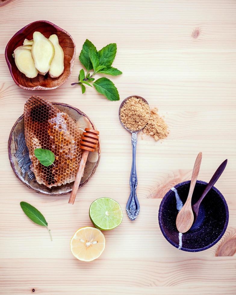 Honey and fruit on a wood table photo