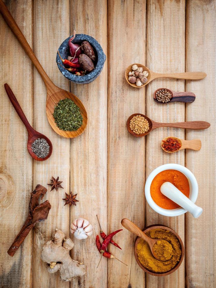 Frame of spices and nuts on wood photo