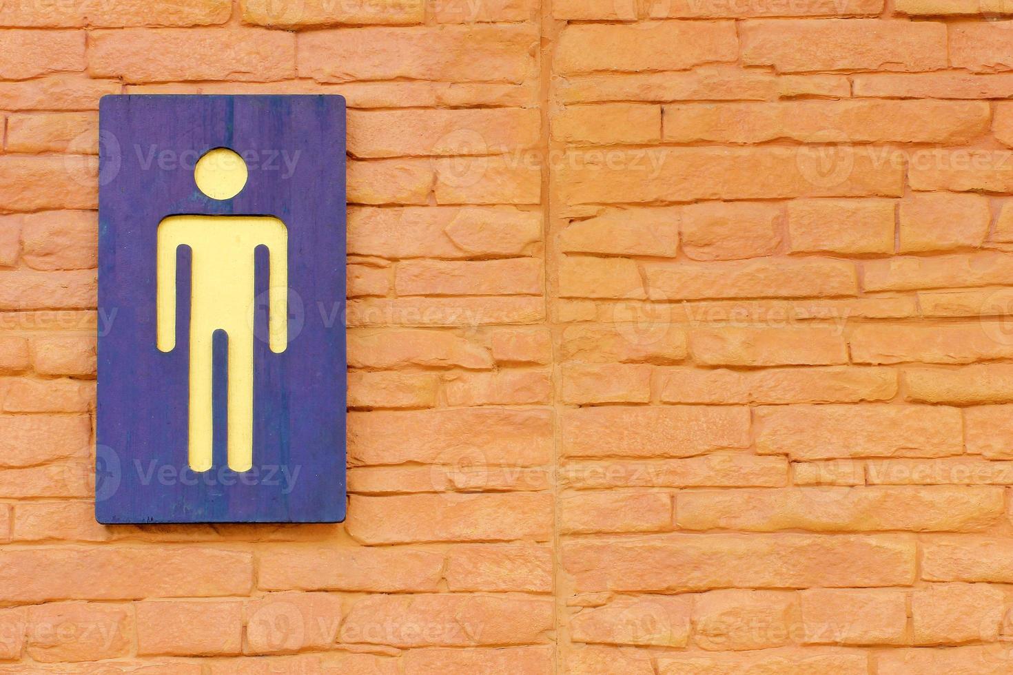 Men toilet sign on brick wall photo